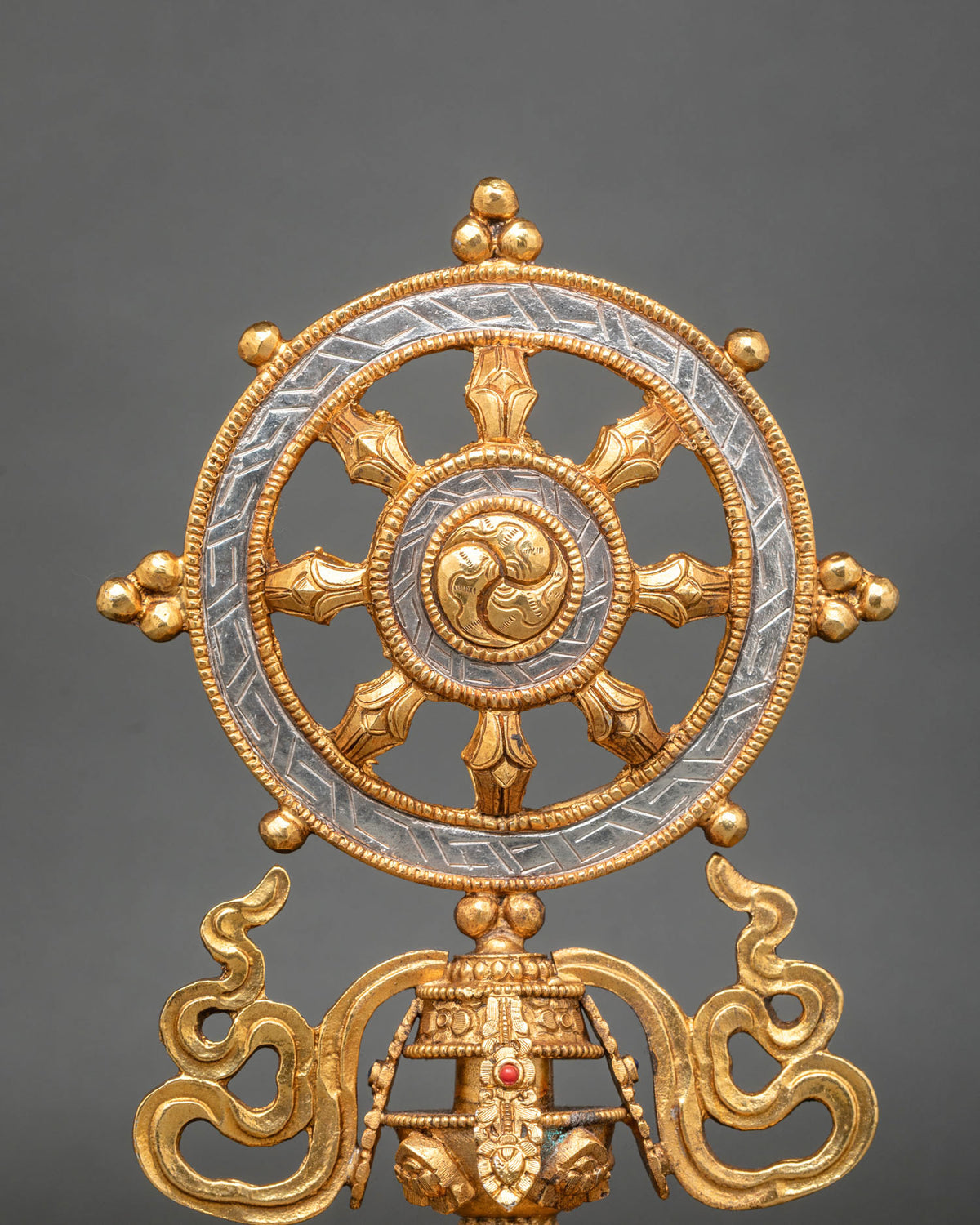 Eight-spoked Dharma Wheel, symbolizing the Noble Eightfold Path with intricate traditional Nepalese metalwork
