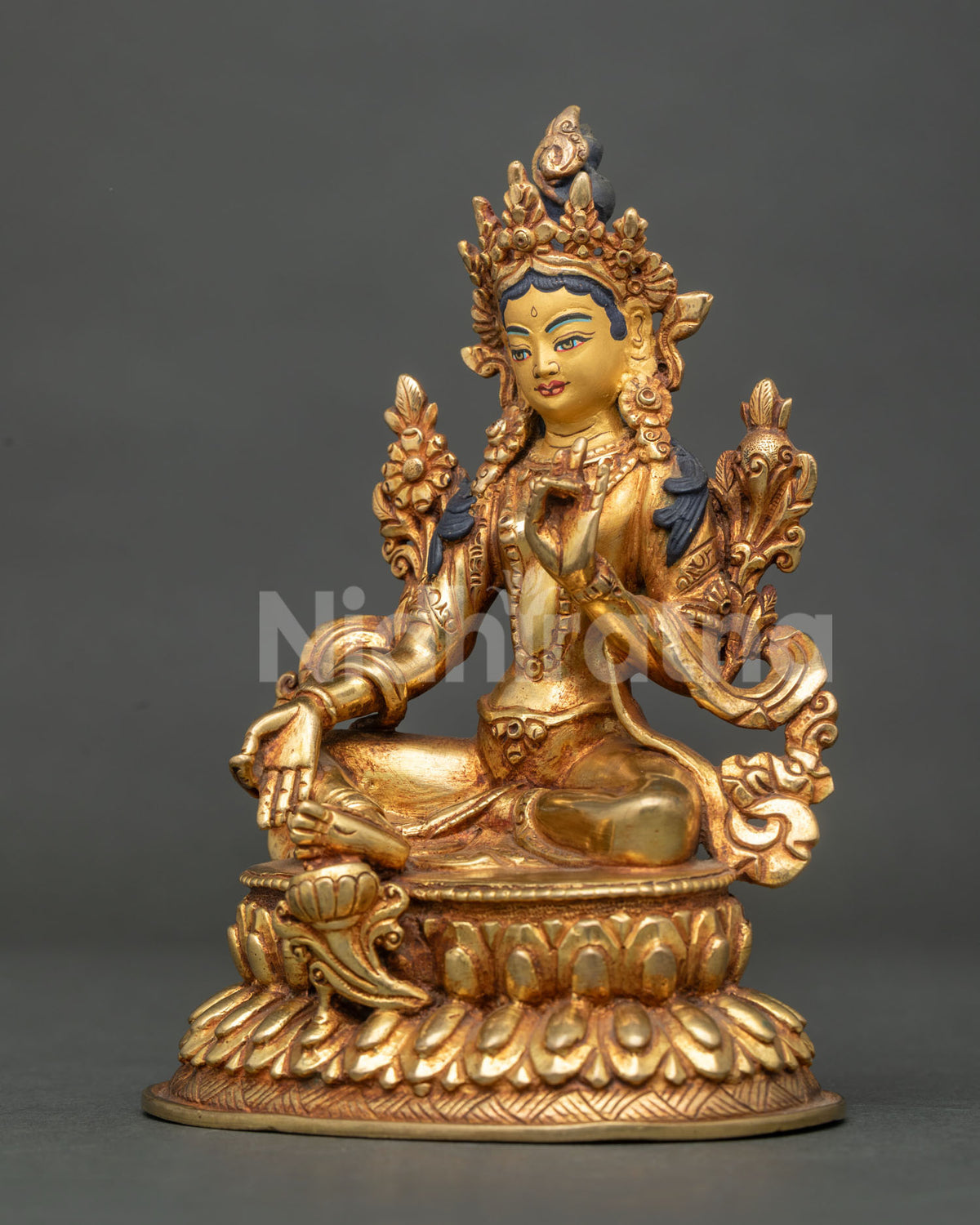 Explore three-quarter view of gold Tibetan Green Tara statue on lotus base, handmade in Nepal