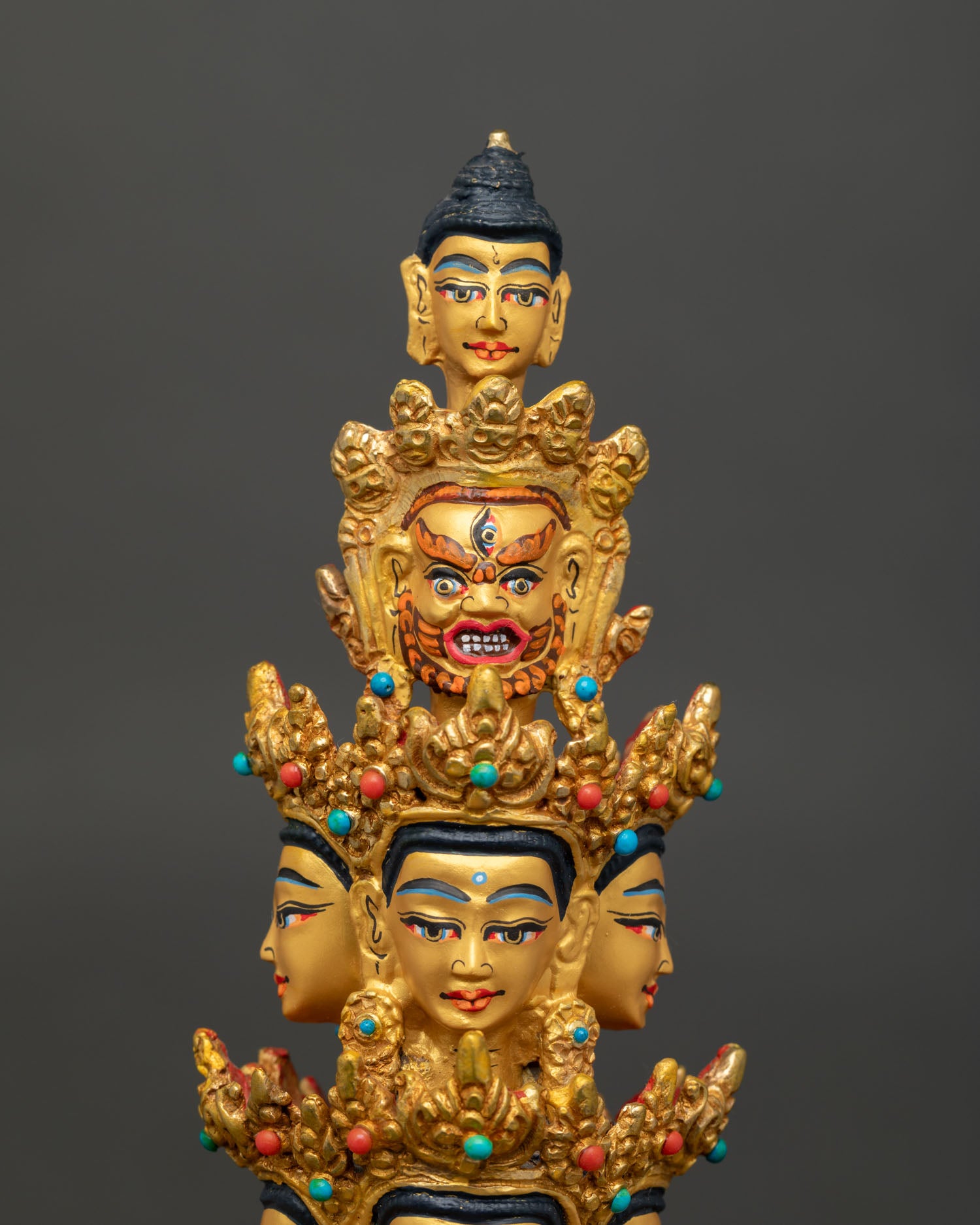 Face close-up of 1000 Armed Chenrezig with eleven heads and 24K gold-painted features