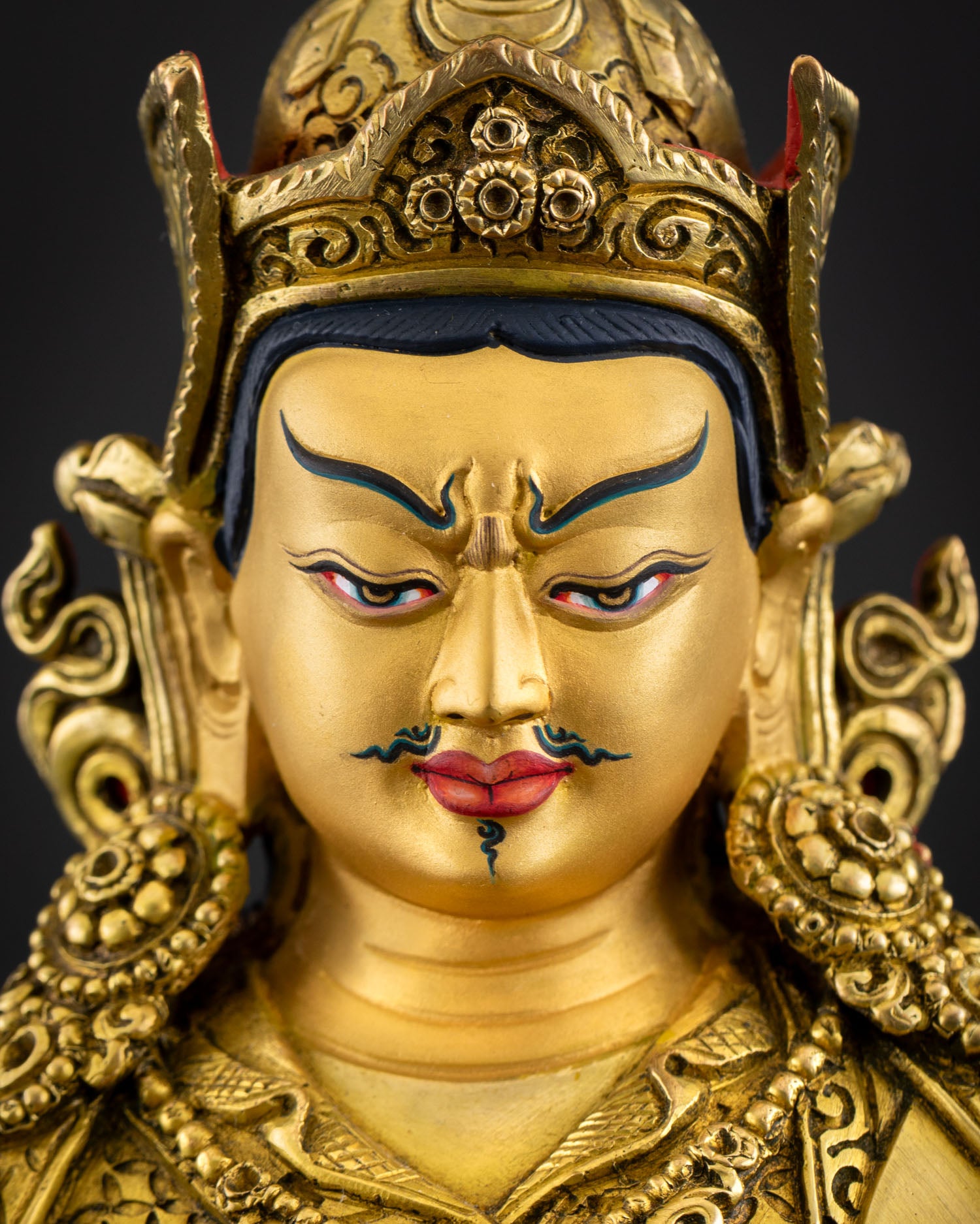 Face close up of Guru Tsokye Dorje with semi-wrathful expression and lotus hat