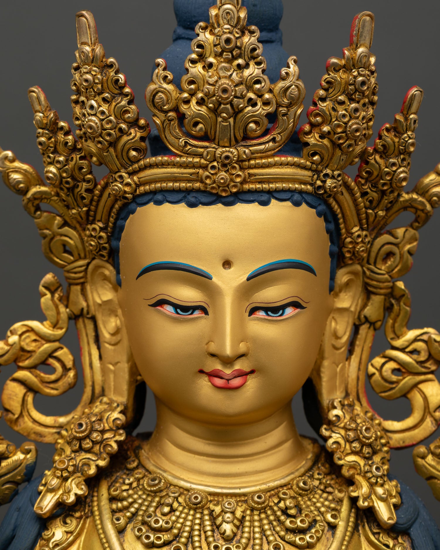 face close up of maitreya buddha, gold painted serene expression future buddha