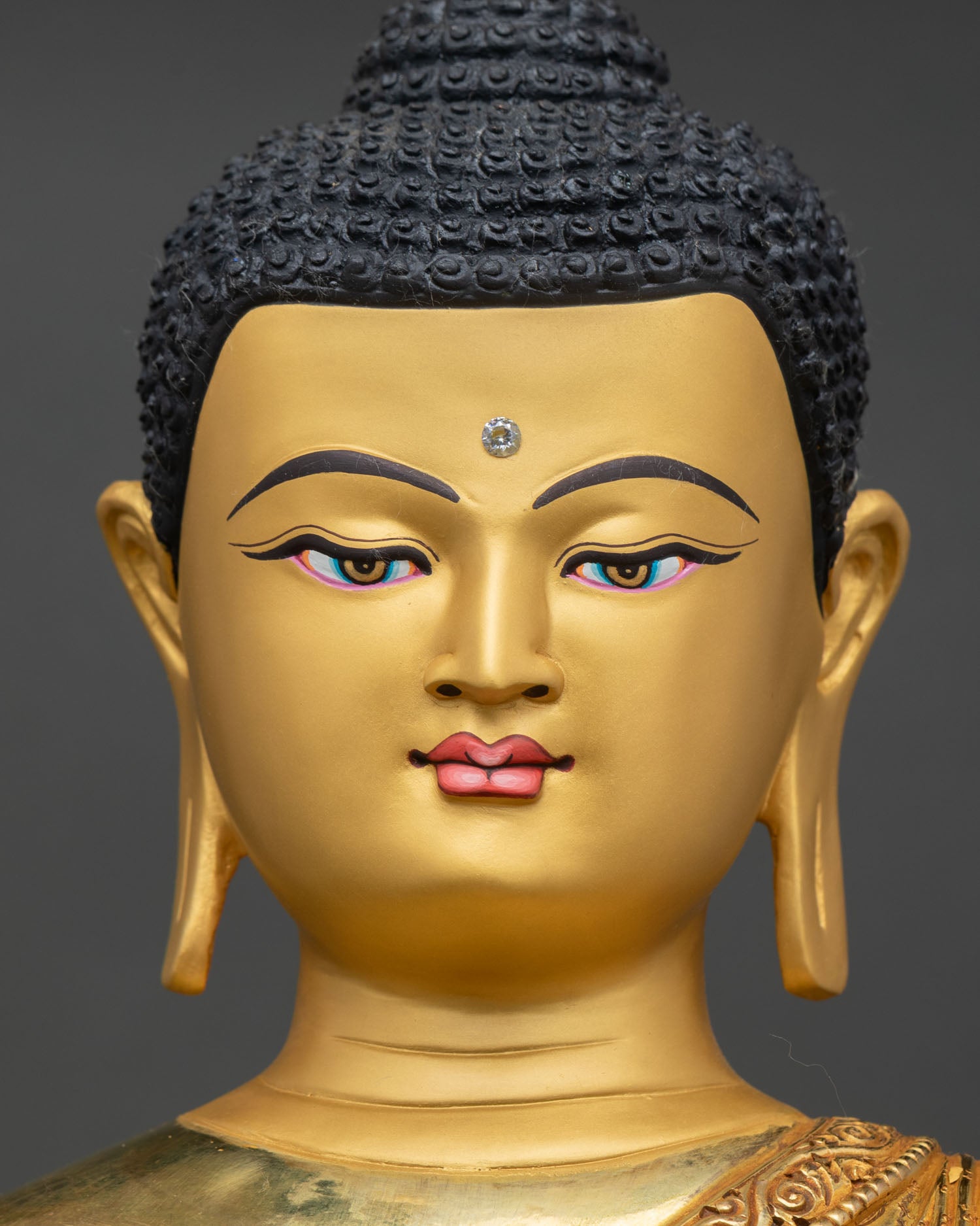 face close up shakyamuni buddha serene gold face bhumisparsha mudra nepal artisan detail