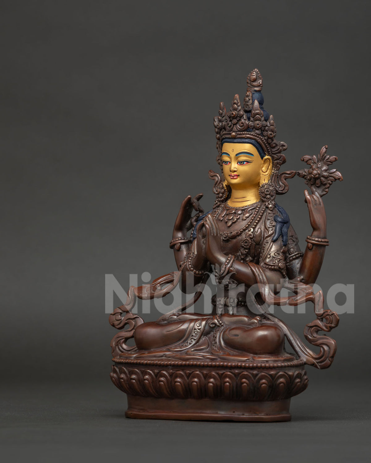 Four armed Chenrezig statue standing on hand carved lotus pedestal with silk garment.
