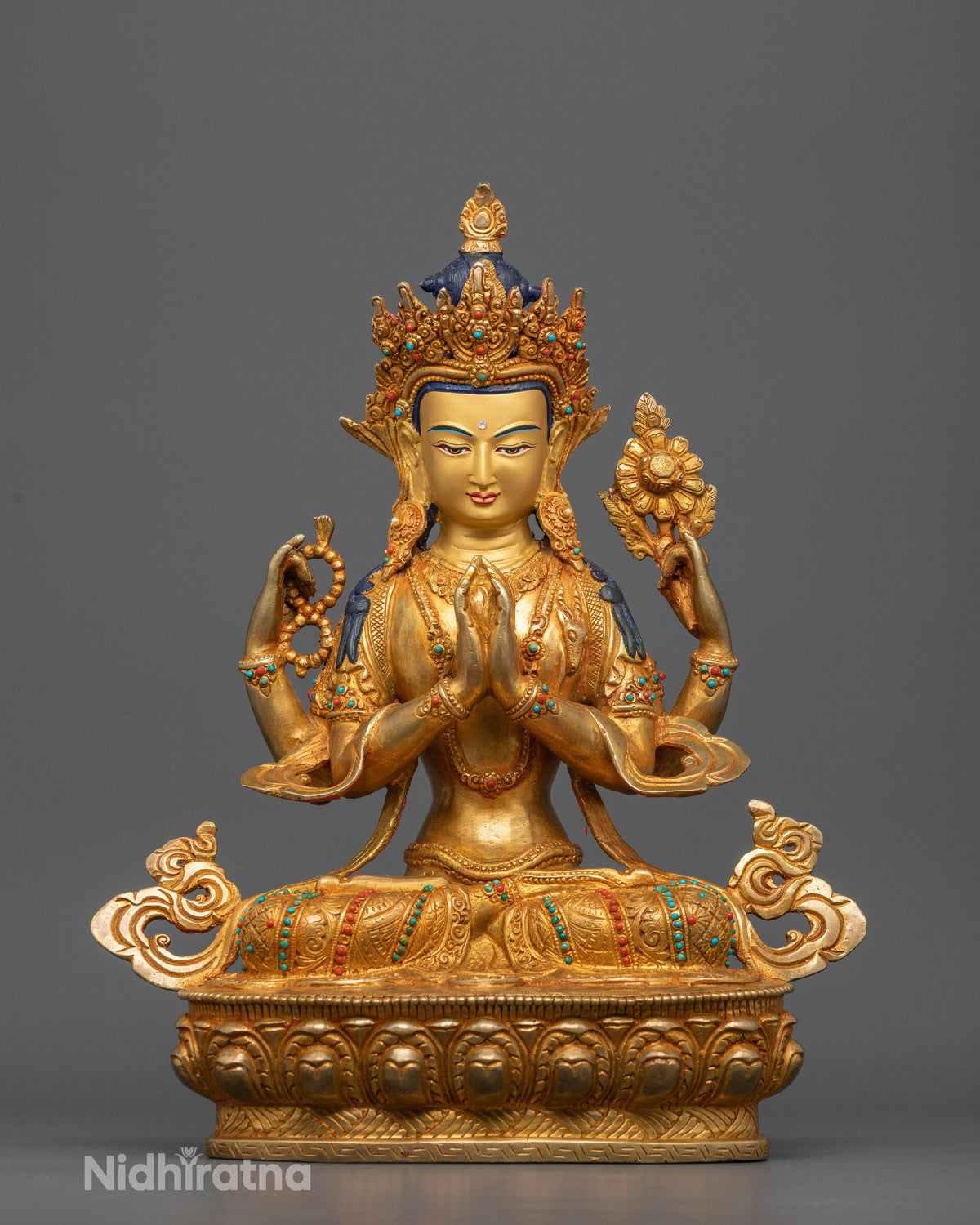 Four armed Chenrezig statue with gold fire gilding and semi precious stones from Nepal