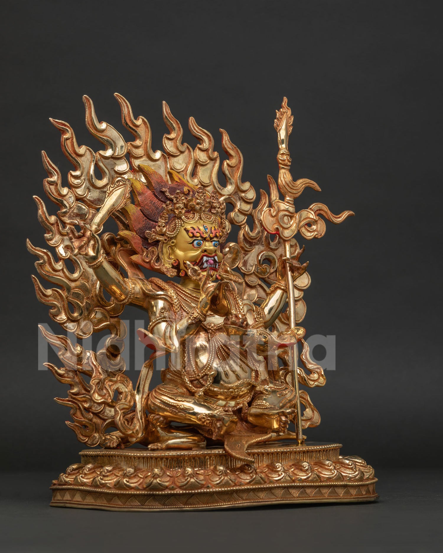 Four-Armed Mahakala holding sword khatvanga staff skull cup and kapala.