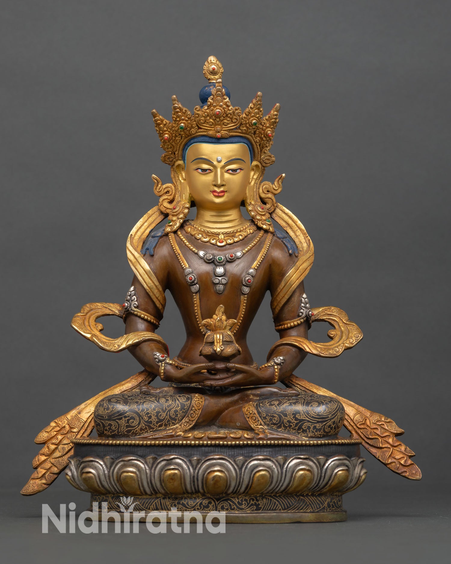Front view of Amitayus statue, copper gold-gilded oxidized finish, silver-plated detailing, longevity Buddha seated on lotus throne, Nepal craftsmanship