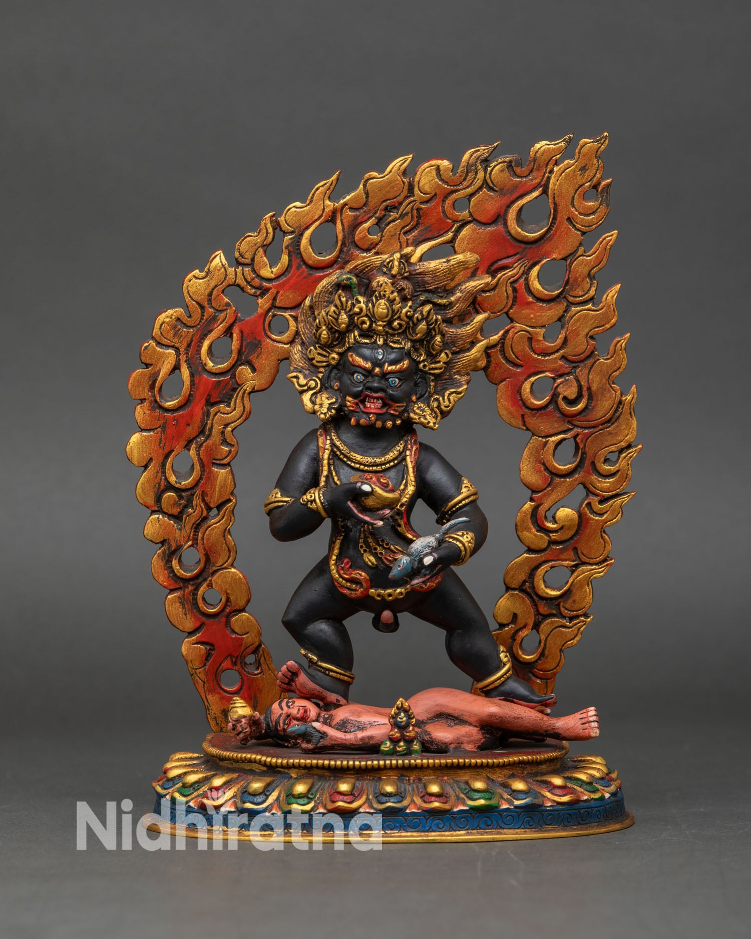 Front view of Black Dzambhala statue, copper sculpture Tibetan Buddhist wealth deity seated on lotus base