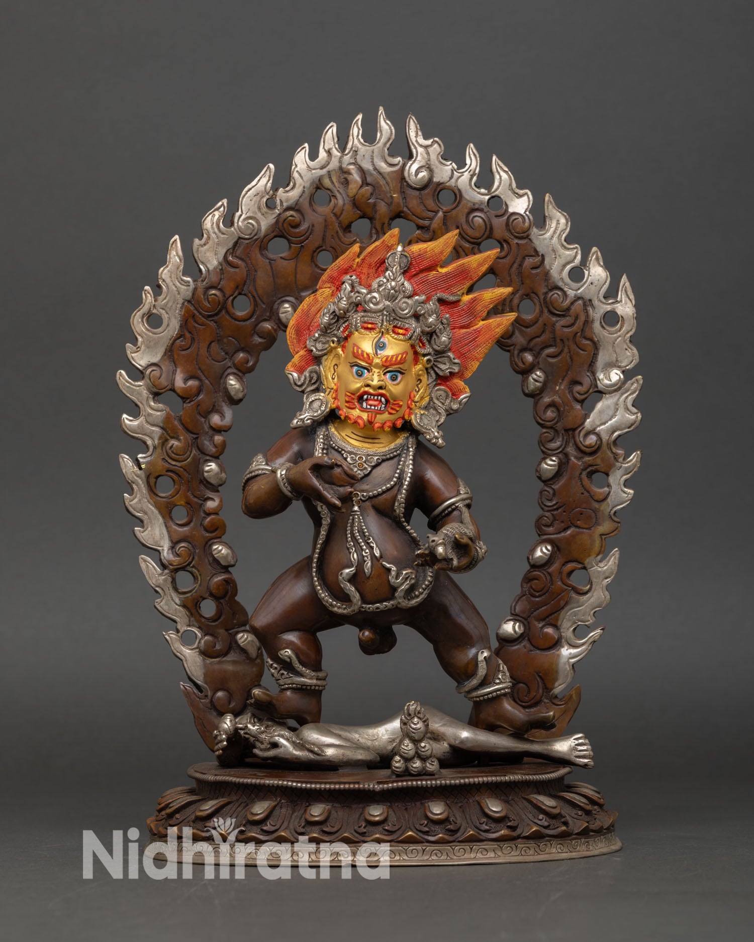 Front view of Black Dzambhala statue handcrafted copper sculpture oxidized silver plated finish gold painted face wrathful Buddhist wealth deity Nepal