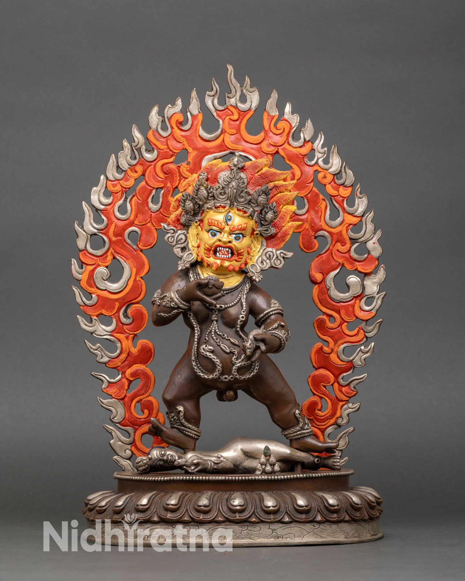 Front view of Black Dzambhala statue wrathful halo skull cup jewel mongoose Nepal sculpture