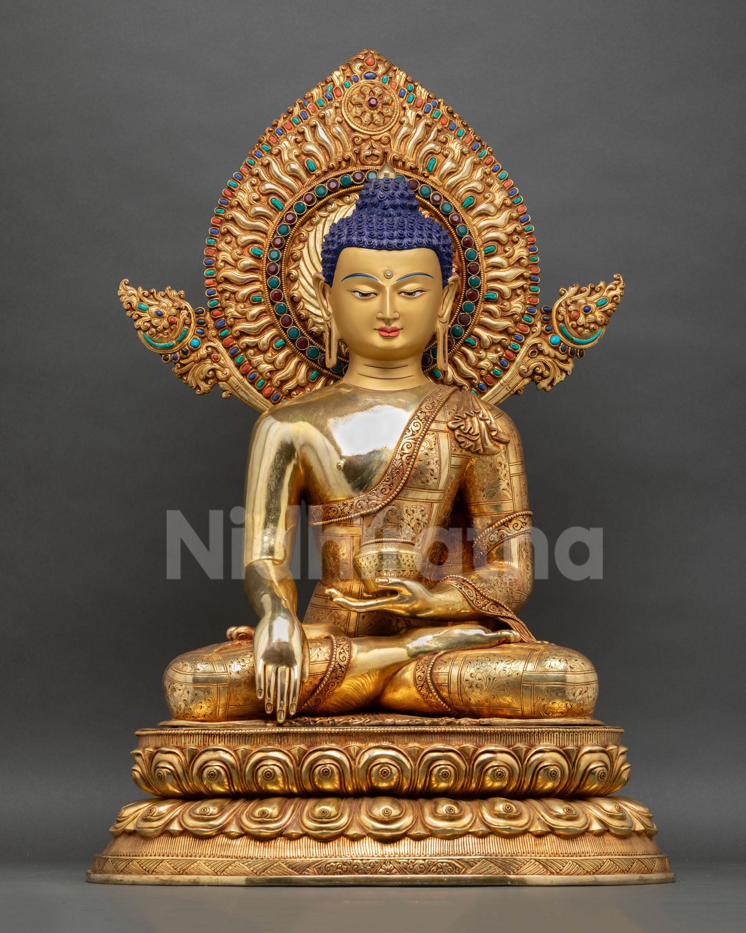Front view of Buddha Shakyamuni statue handmade in Nepal by Newari artist copper sculpture with gold gilding gold painted face double lotus throne for dharma center and altar decor