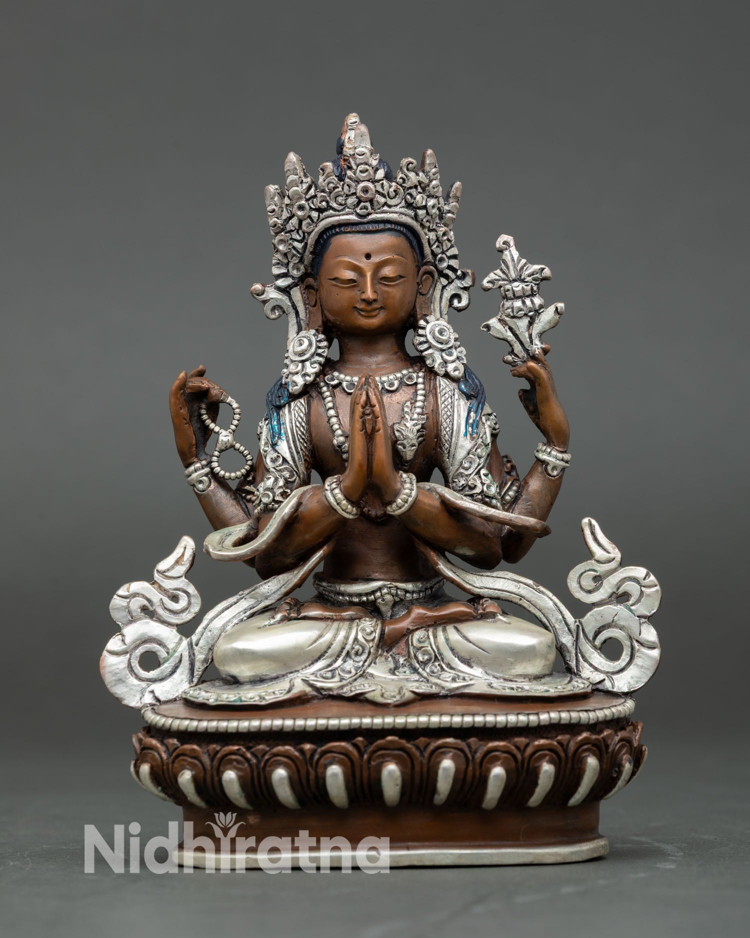 Front view of Chenrezig statue, copper oxidized silver plated, Buddhist compassion deity, seated lotus pedestal Nepal sculpture
