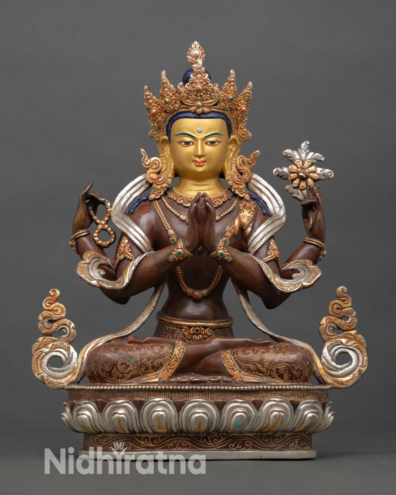 Front view of Chenrezig statue, copper oxidized finish, silver plated and gold gilded details, seated in meditation posture for altar and home decor