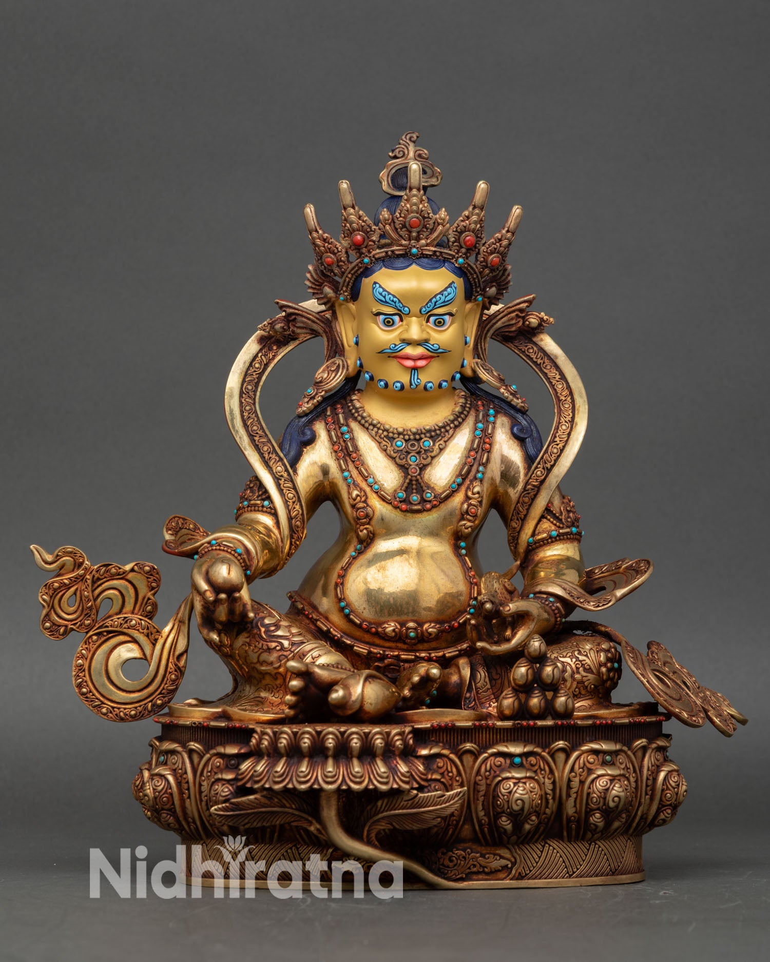 front view dzambhala statue gold-painted wealth god on lotus base
