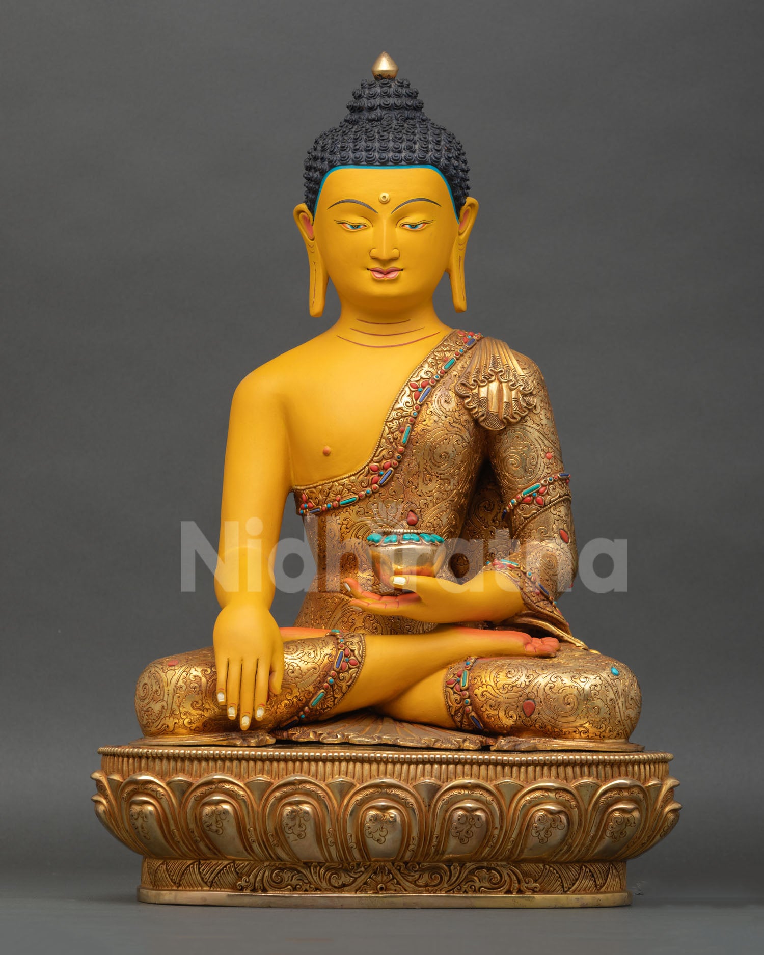 Front view of Gautama Shakyamuni Buddha statue in copper with gold gilded finish and semi precious stones for Buddhist altar decor