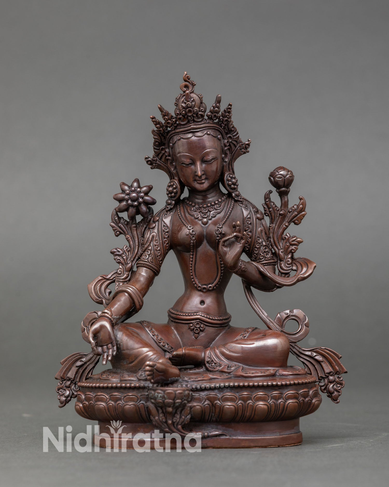 Front view of Green Tara statue handcrafted by Newari artisans in Kathmandu Nepal oxidized copper sacred Buddhist deity on lotus pedestal