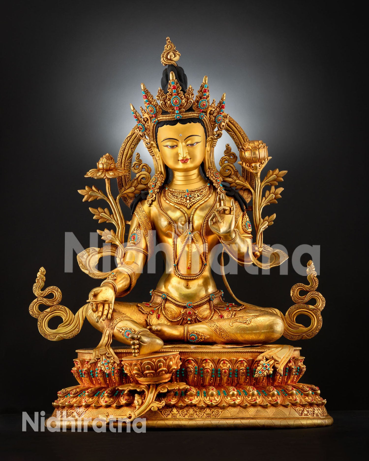 Front view of Green Tara statue handcrafted in Nepal with fire gilded gold turquoise and coral stones seated on lotus pedestal in Lalitasana posture