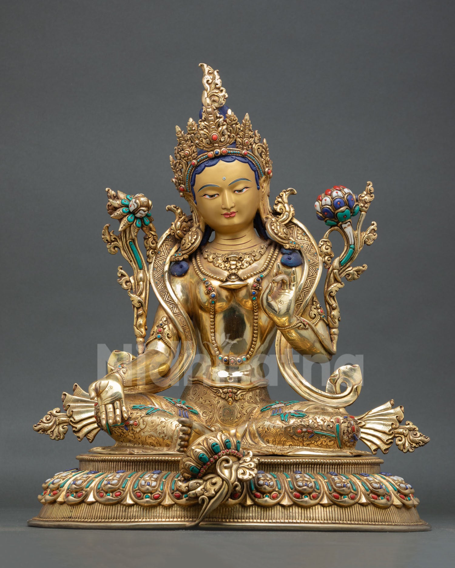 Front view of Green Tara statue with 24K gold detailing copper craftsmanship and semi precious stone inlays from Nepal