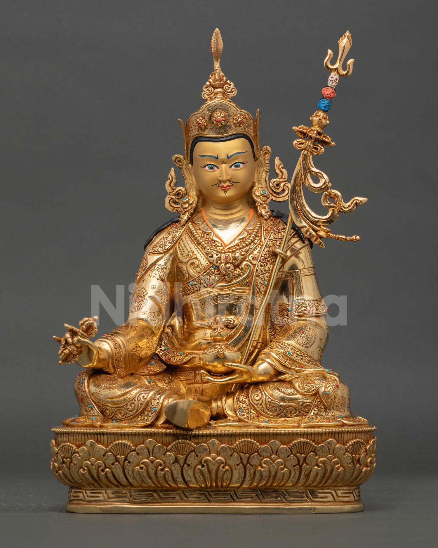 Front view of Guru Rinpoche statue handmade in copper with 24K fire gilding gold painted face and semi precious stones