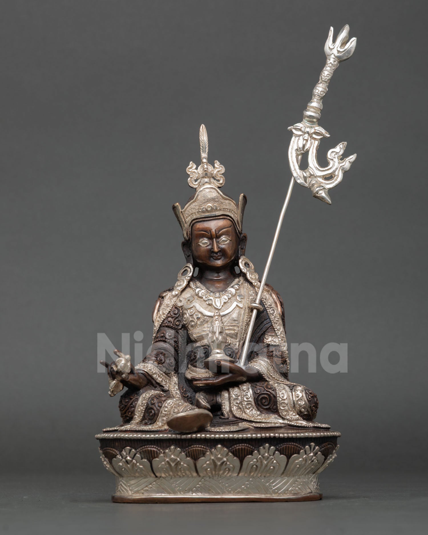 Front view of Guru Rinpoche statue Nepal handcrafted copper sculpture oxidized silver plated finish lotus throne royal seated posture