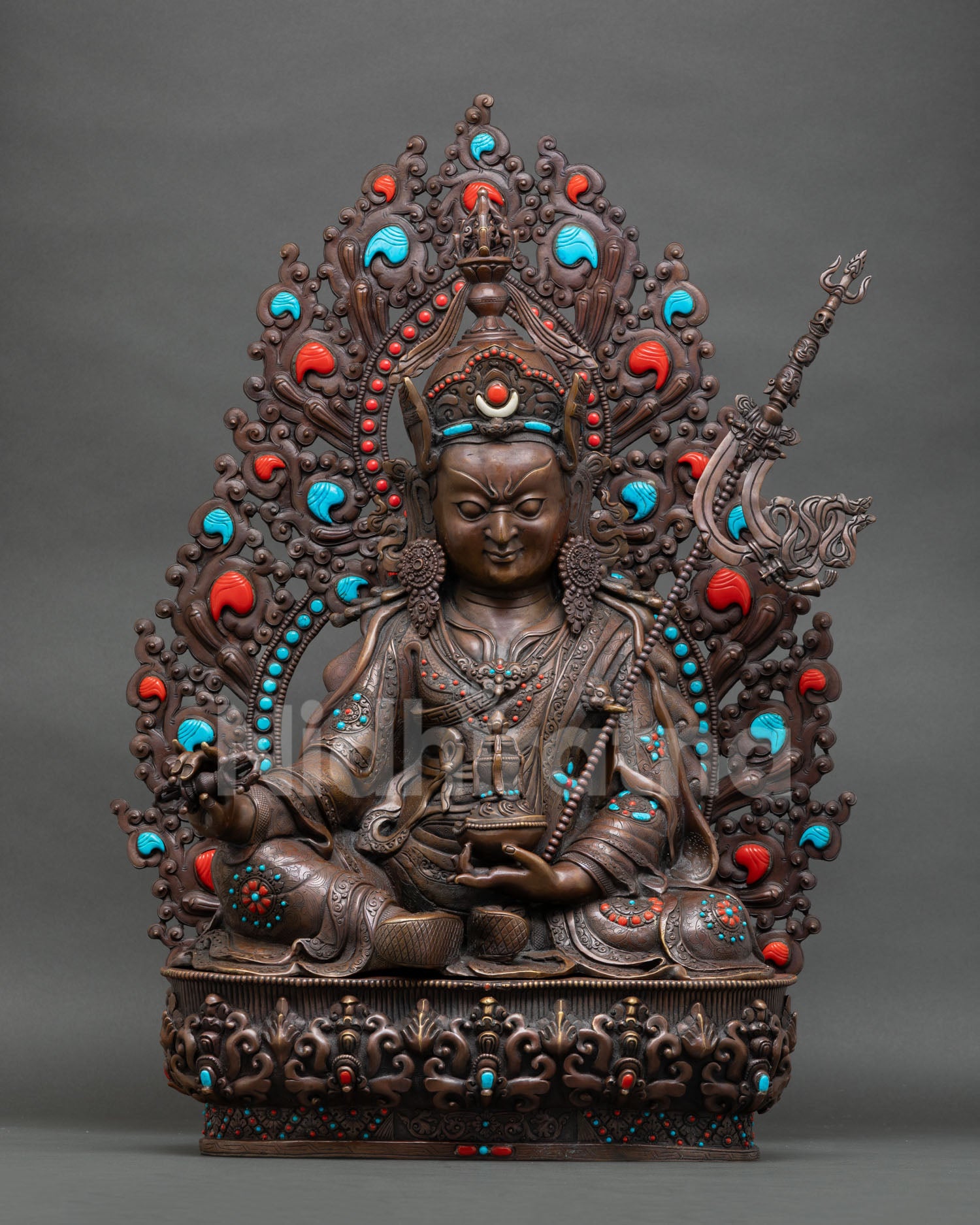 Front view of Guru Rinpoche statue with oxidized finish lotus throne and ornate halo from Nepal