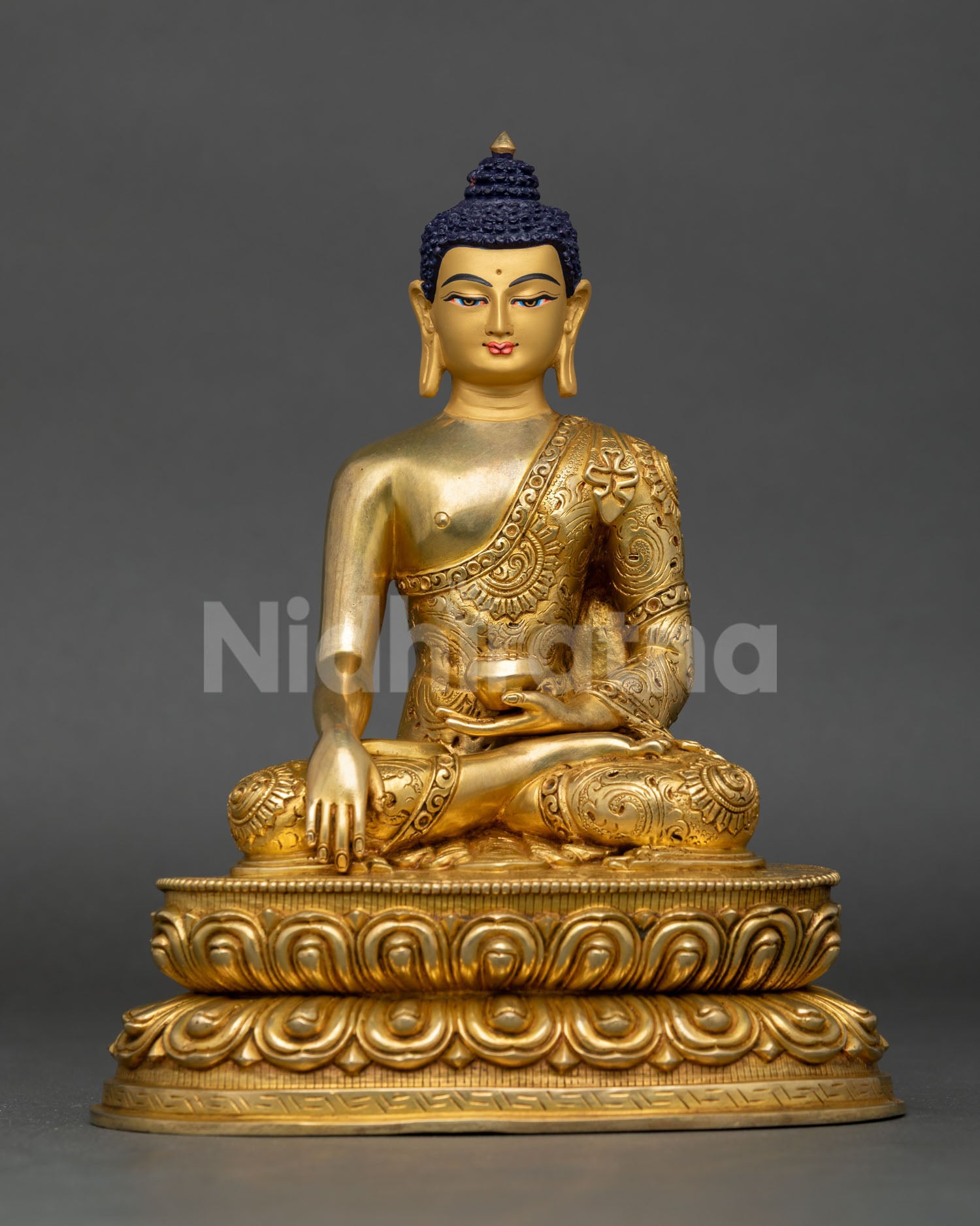 Front view of handcrafted Shakyamuni Buddha statue in gold detailed copper from Nepal