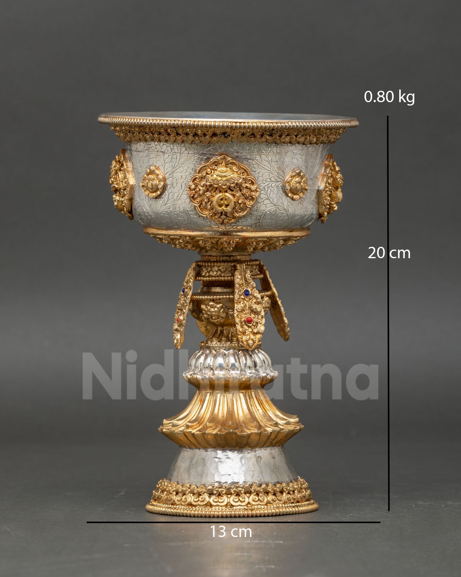 Front view of Himalayan butter lamp handcrafted in copper alloy with gold and silver plated finish featuring auspicious Buddhist symbols