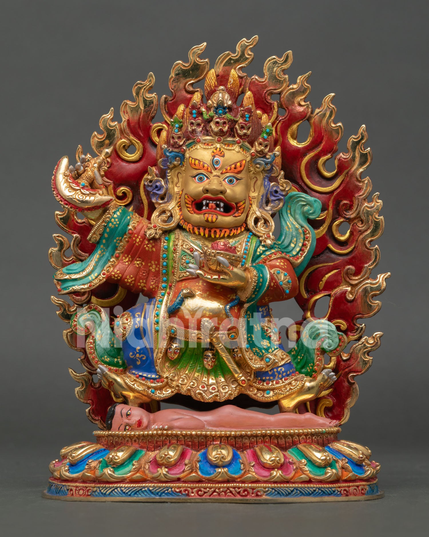 Front view of Mahakala Bernagchen statue handmade in copper with gold gilded finish and blazing halo holding sacred implements