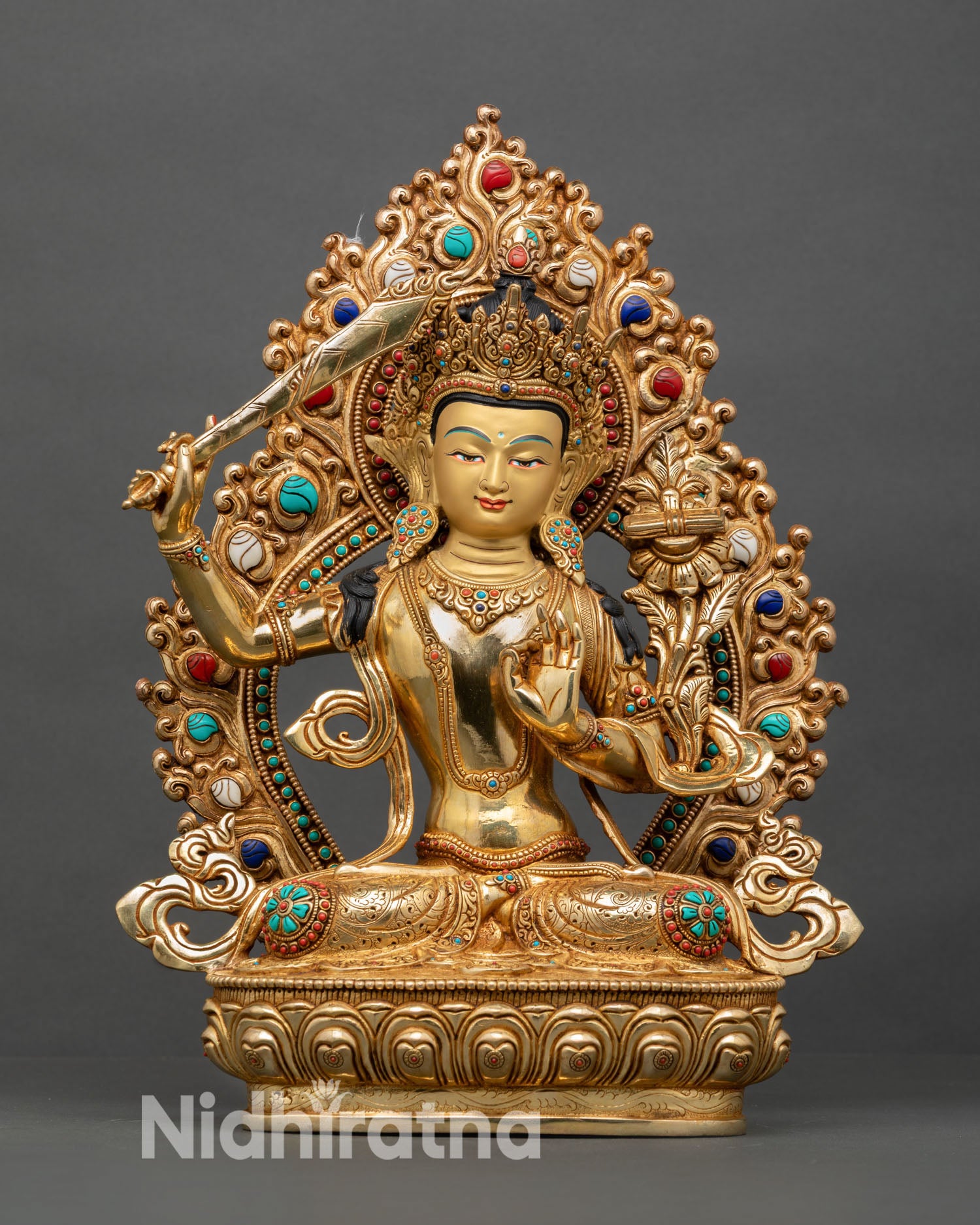Front view of Manjushri statue, copper gold gilded fire finish, gold painted-face, seated lotus throne, Himalayan Buddhist wisdom deity sculpture