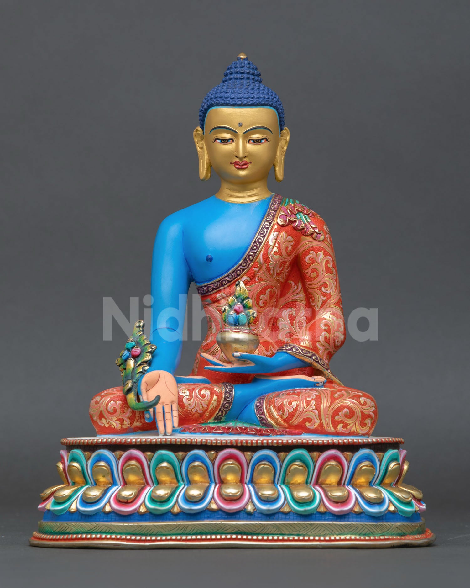 Front view of Medicine Buddha statue handmade in Nepal by skilled artisans lost wax copper sculpture with gold gilded face blue hued body for healing and meditation