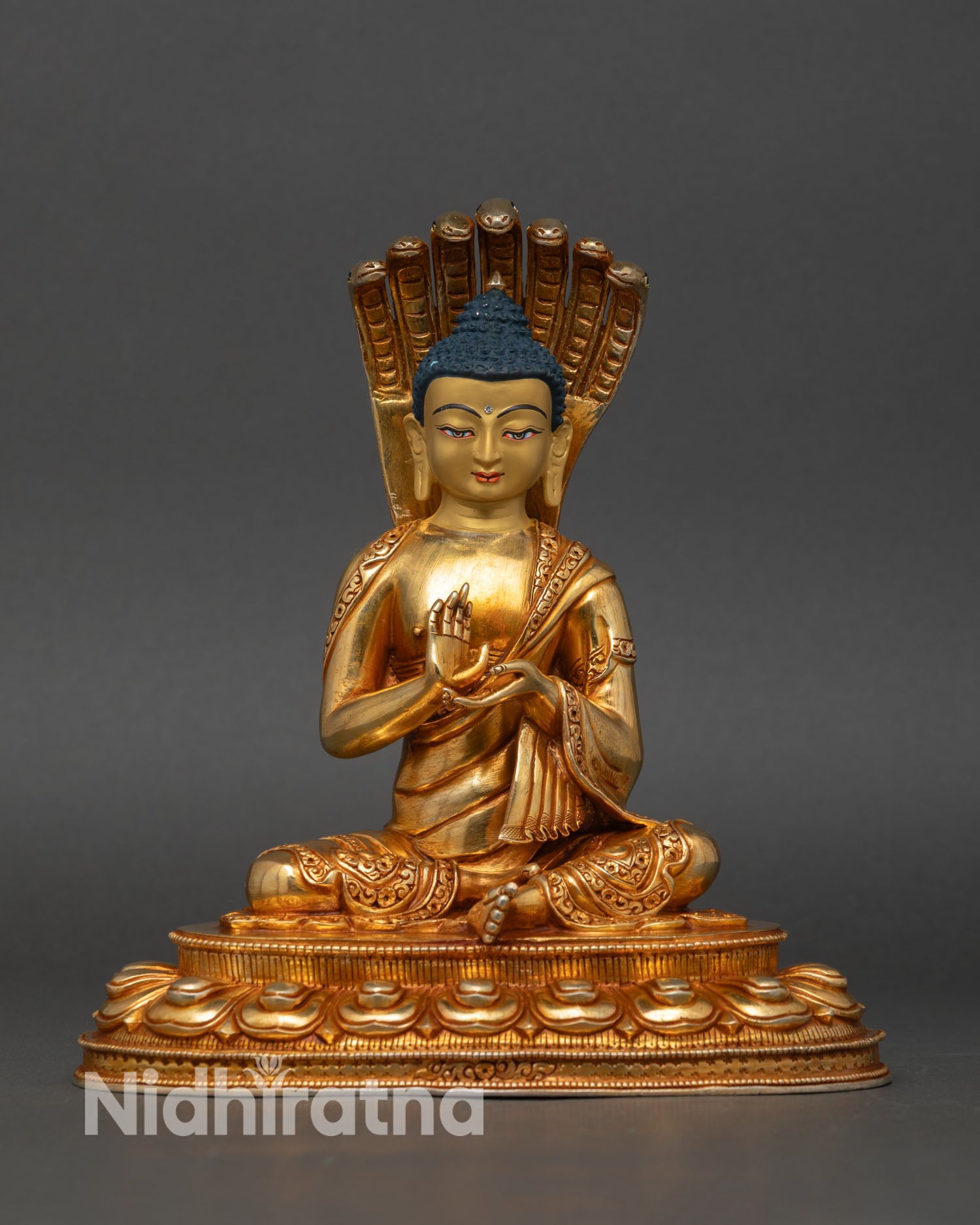 front view nagarjuna statue gold gilded mahasiddha lotus base buddhist philosopher nepal