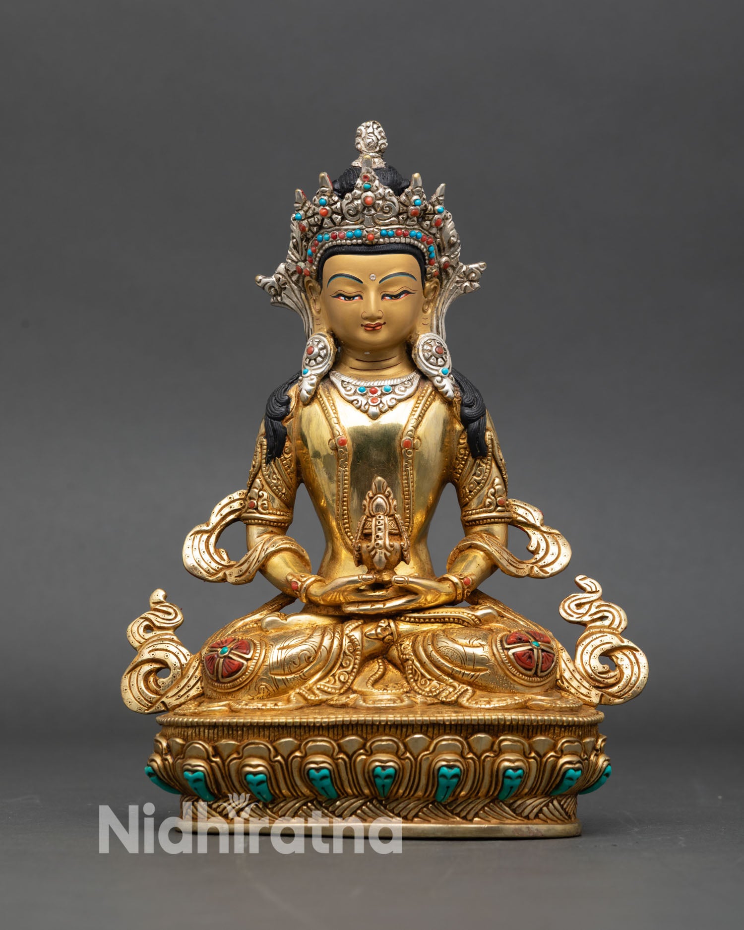 front view of amitayus copper statue with gold painted face and silver crown