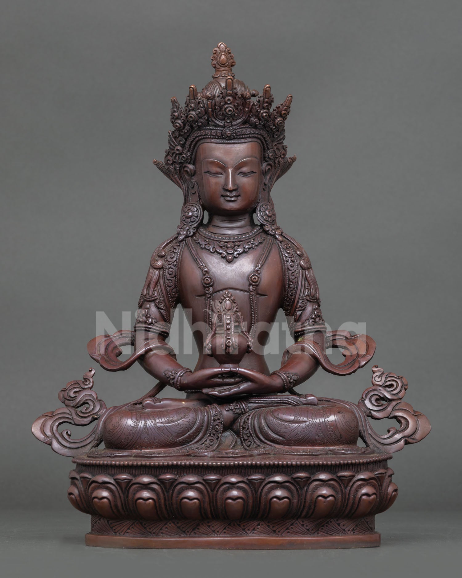 Front view of Amitayus statue in oxidized copper, seated on lotus throne with sacred vase