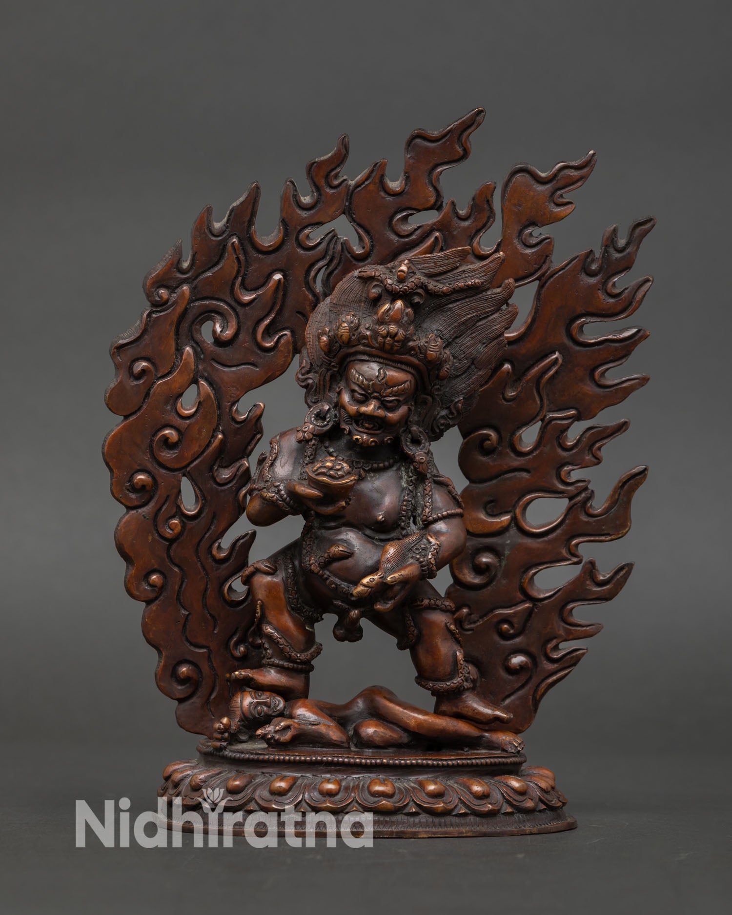 Front view of Black Dzambhala statue made from oxidized copper in Nepal, crafted using lost wax casting