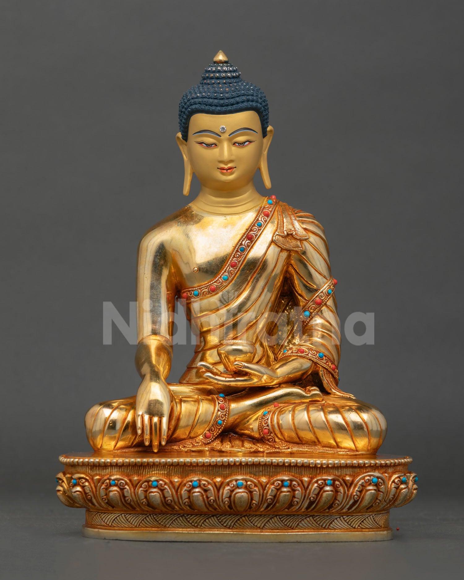 Front view of Buddha Shakyamuni statue, handmade in copper with gold gilding and semi-precious stones from Nepal