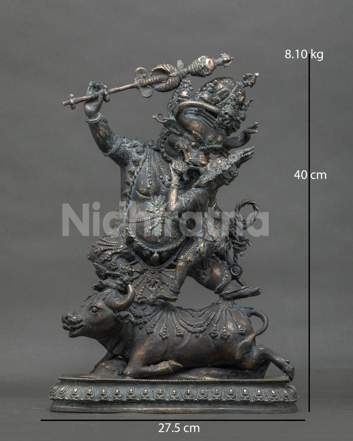 Front view of buffalo-headed Yamantaka Vajrabhairava bronze statue atop prostrate buffalo, Nepal