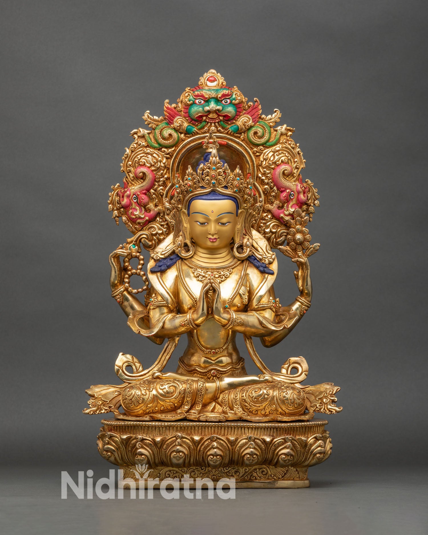 Front view of Chenrezig statue, four-armed copper with gold-painted face Nepalese art