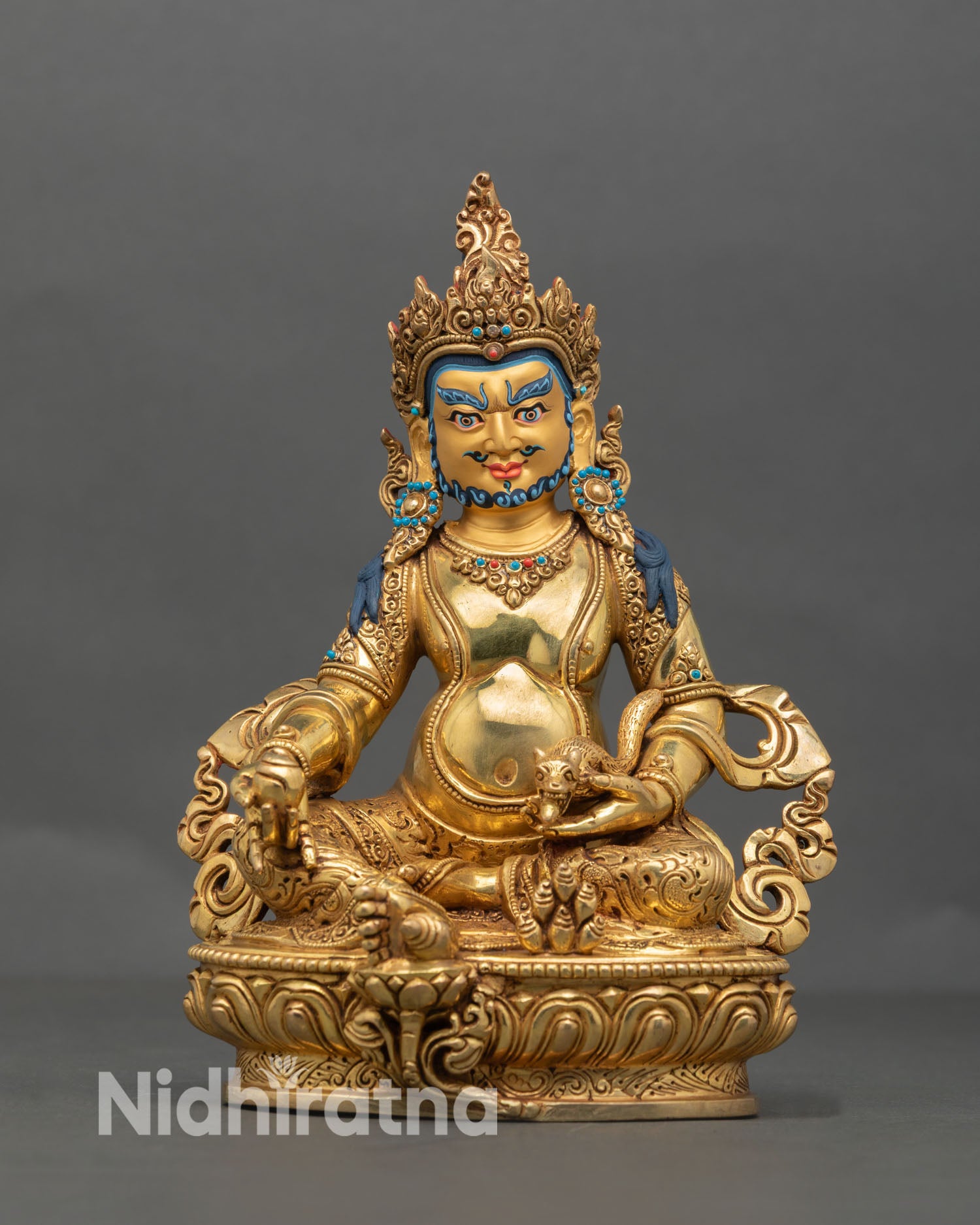 Front view of Dzambhala statue handcrafted in Nepal in premium copper with gold detailing and gold painted face