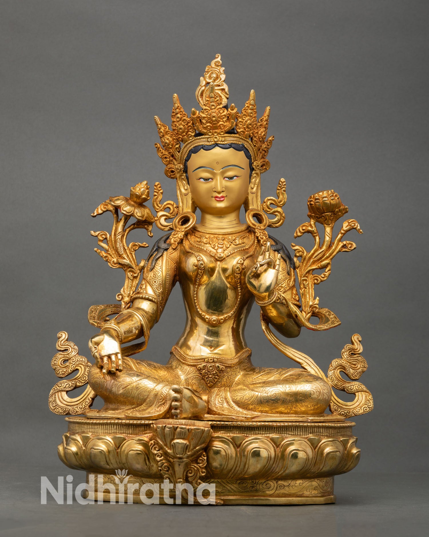 Front view of Green Tara statue handcrafted in Nepal with gold fire gilded finish on lotus pedestal, Buddhist compassion deity