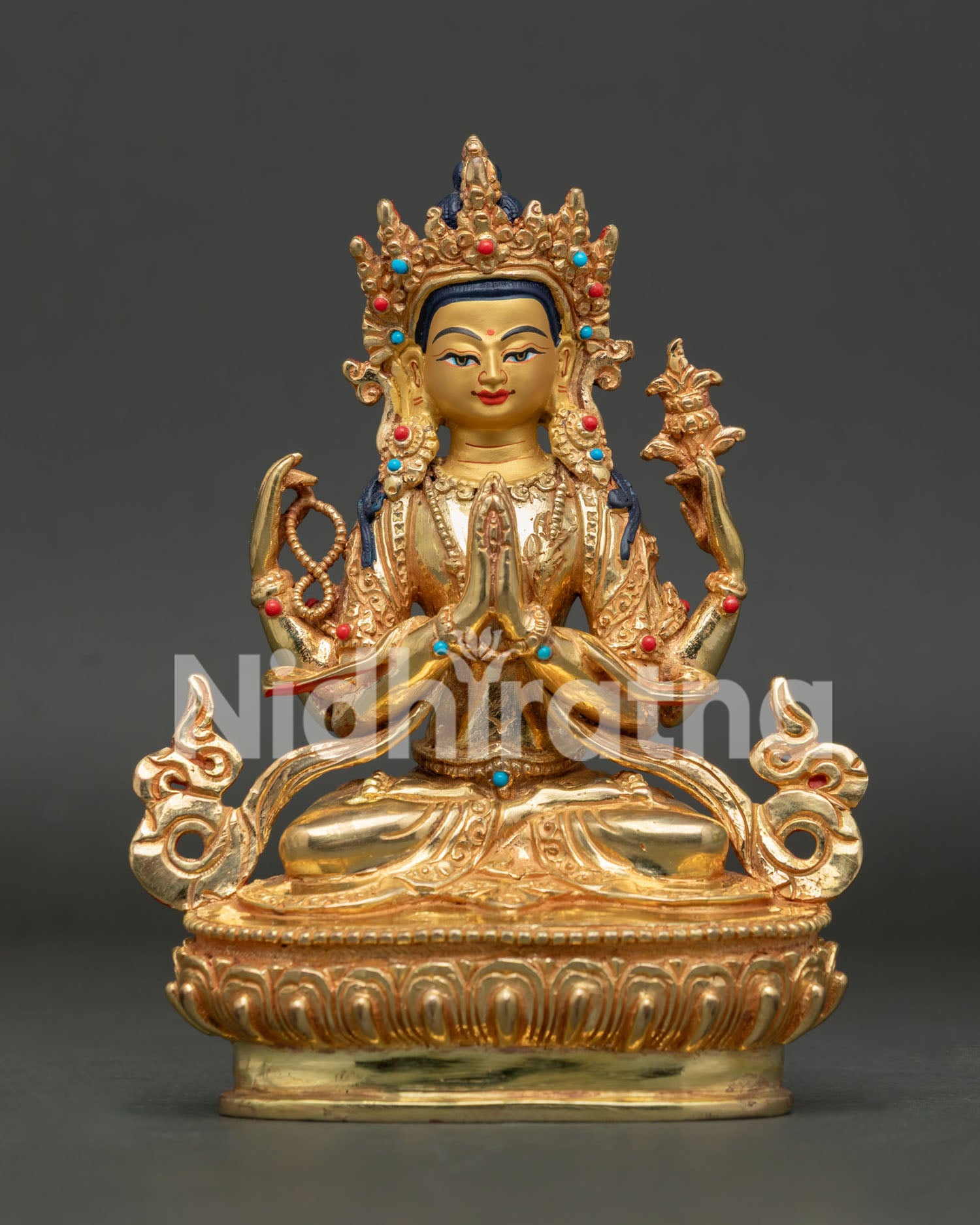Front view of handcrafted Chenrezig Statue in gold gilded copper with semi precious stones from Nepal