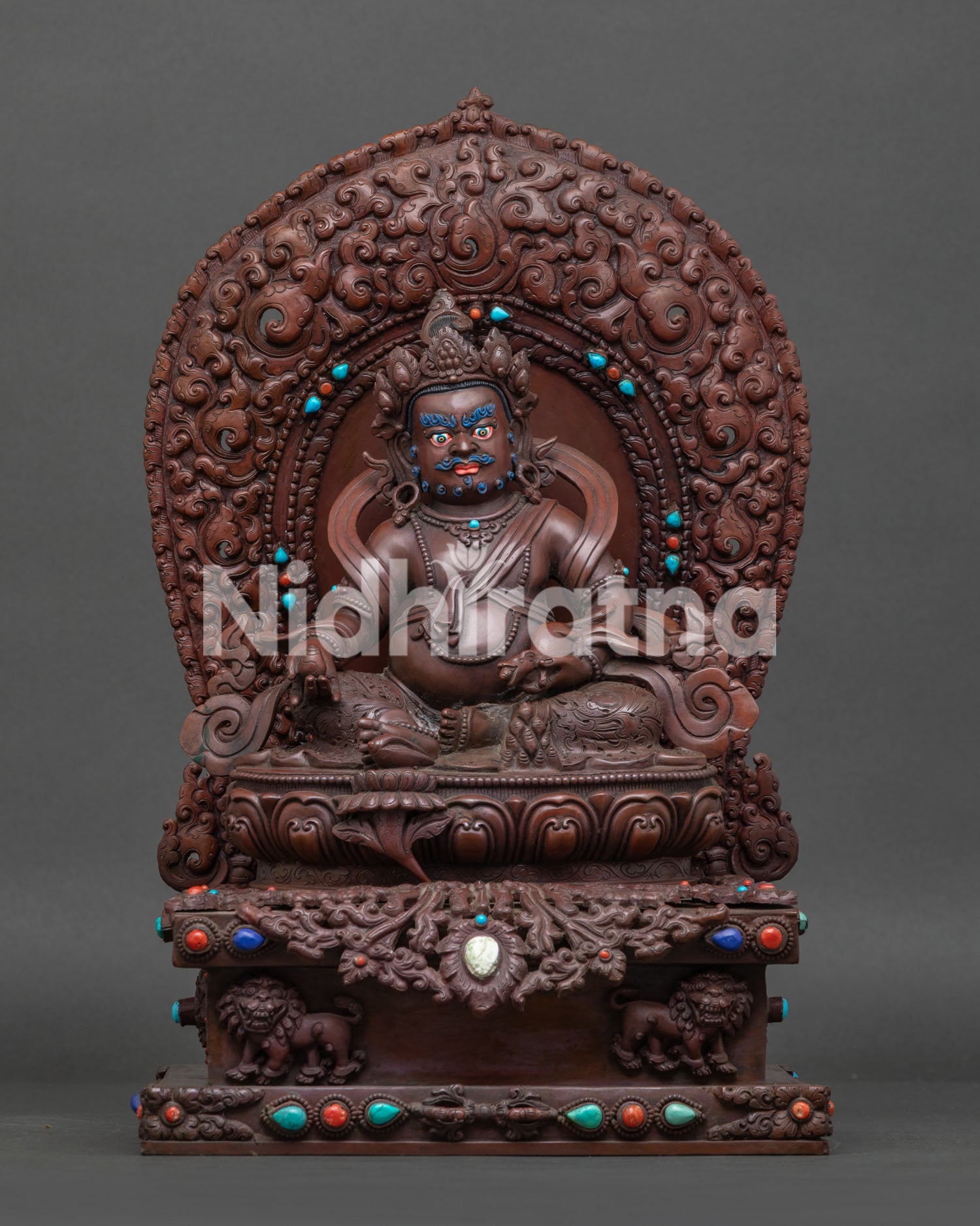 front view of handcrafted Dzambhala statue in oxidized copper with turquoise and coral inlays