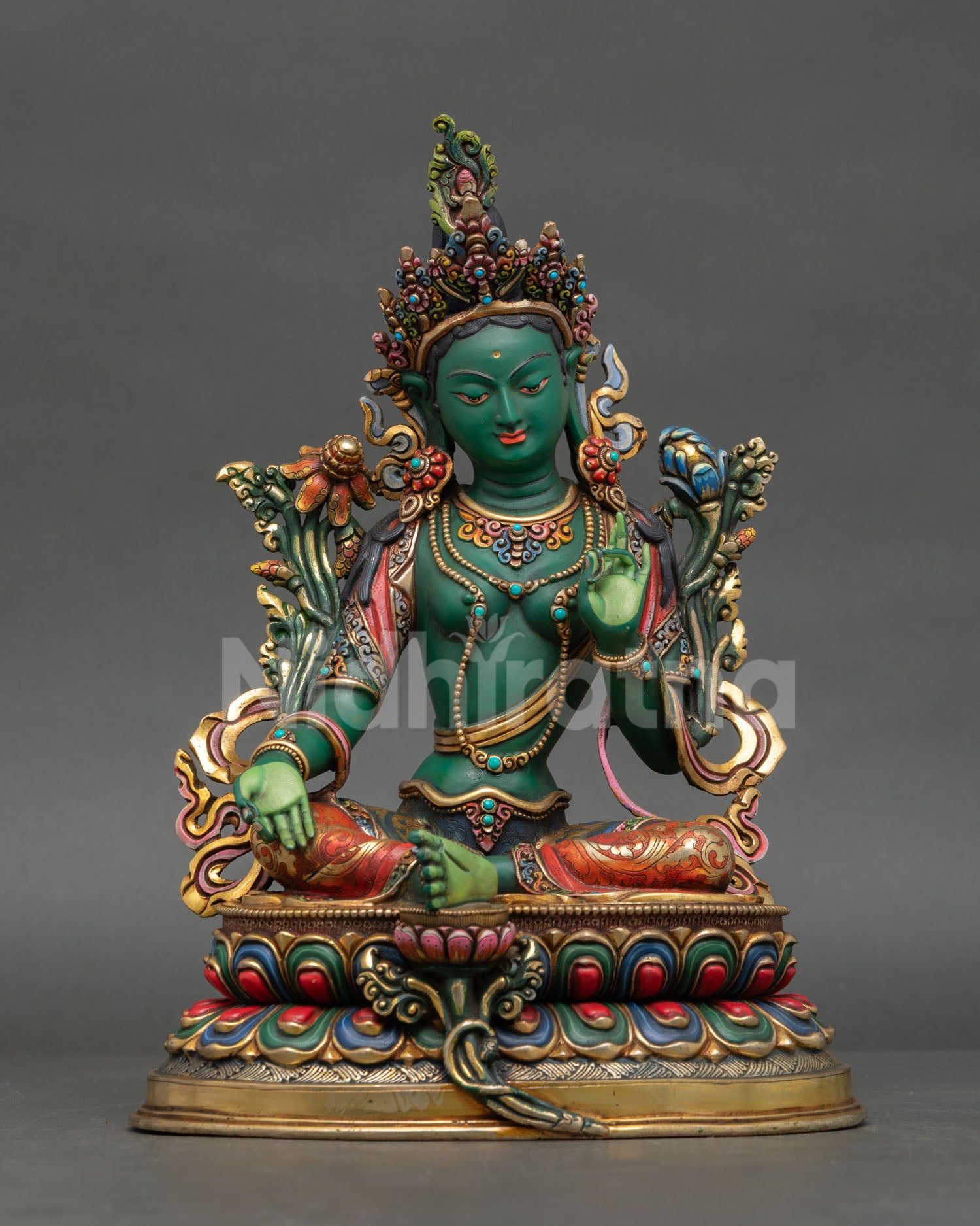 Front view of handcrafted Green Tara statue with deep green body, semi precious stones, and compassionate Buddhist symbolism.
