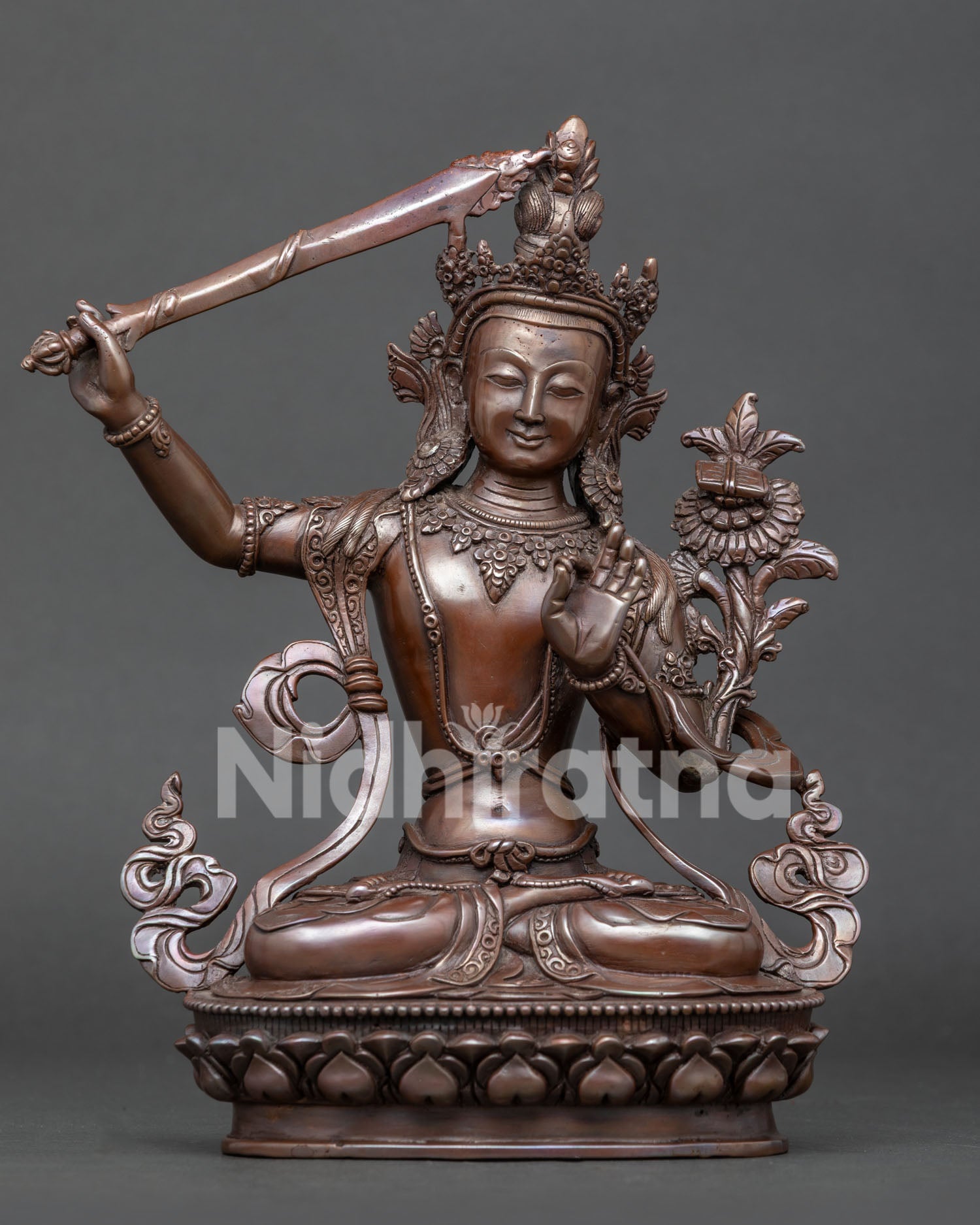 Front view of handcrafted Manjushri statue in oxidized copper from Patan, Nepal