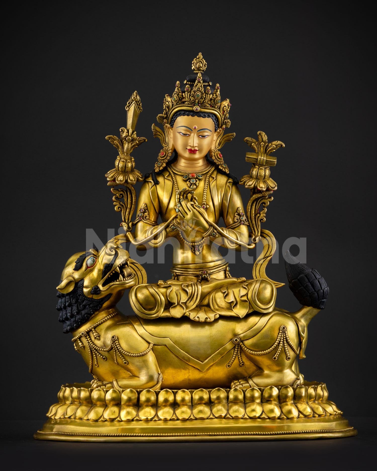 Front view of handcrafted Simhanada Manjushri statue from Nepal in gold gilded copper with roaring lion throne flaming sword of wisdom