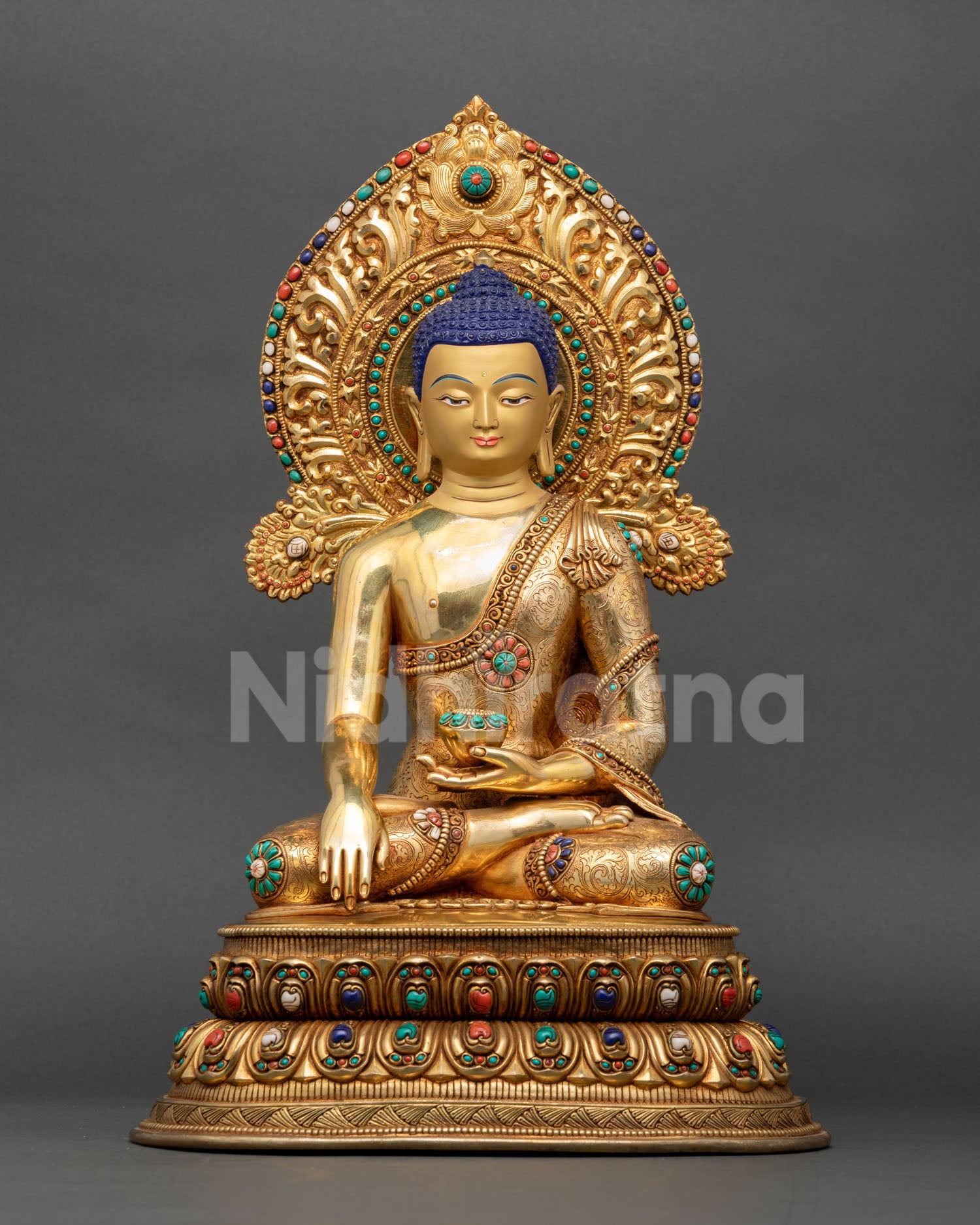 Front view of handmade Buddha Shakyamuni statue with 24K gold gilding, Earth Touching Mudra, and ornate halo crafted by Newari artisans in Nepal.