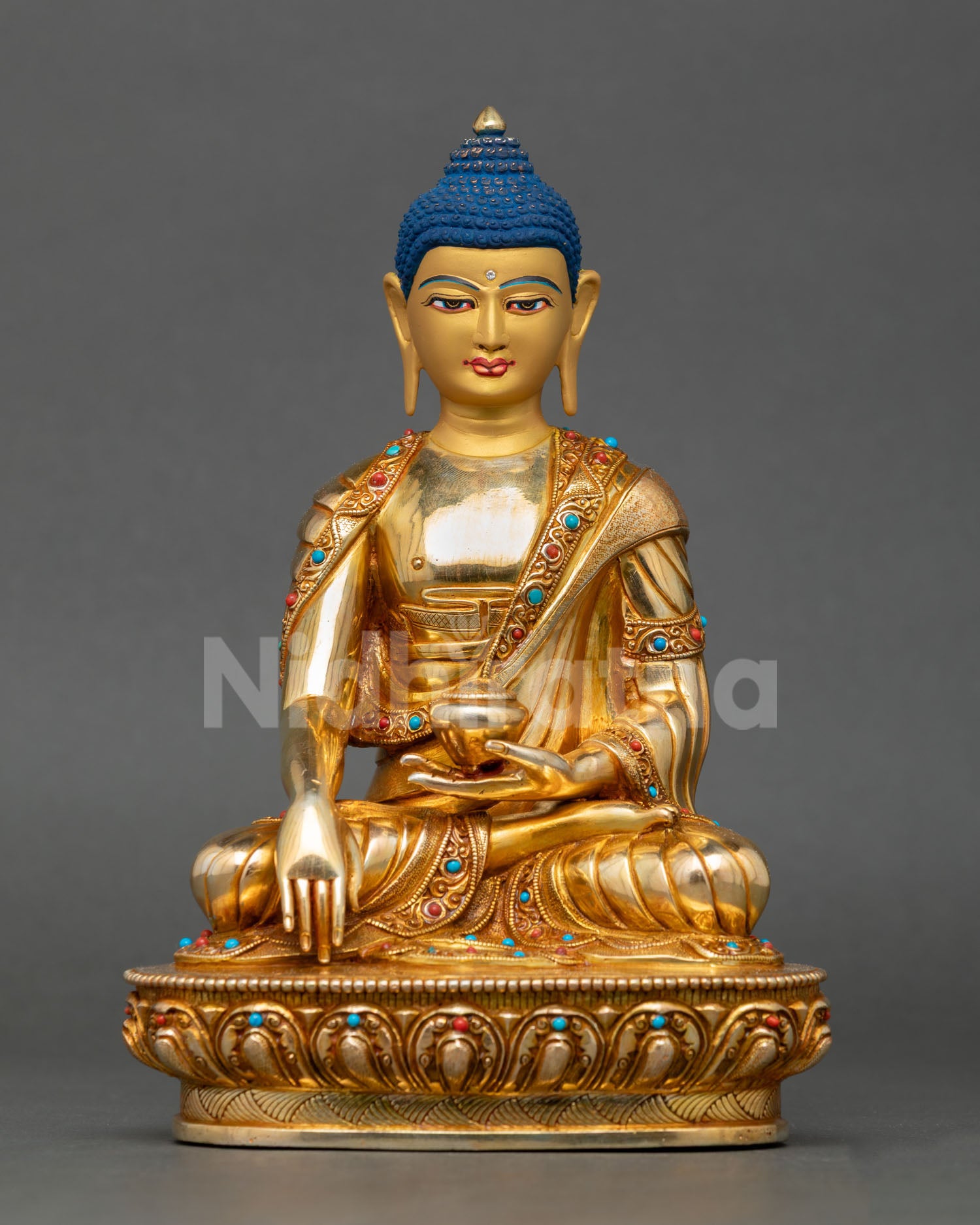 Front view of a handmade Buddha Shakyamuni statue with a gold-gilded copper body and gemstone decorations