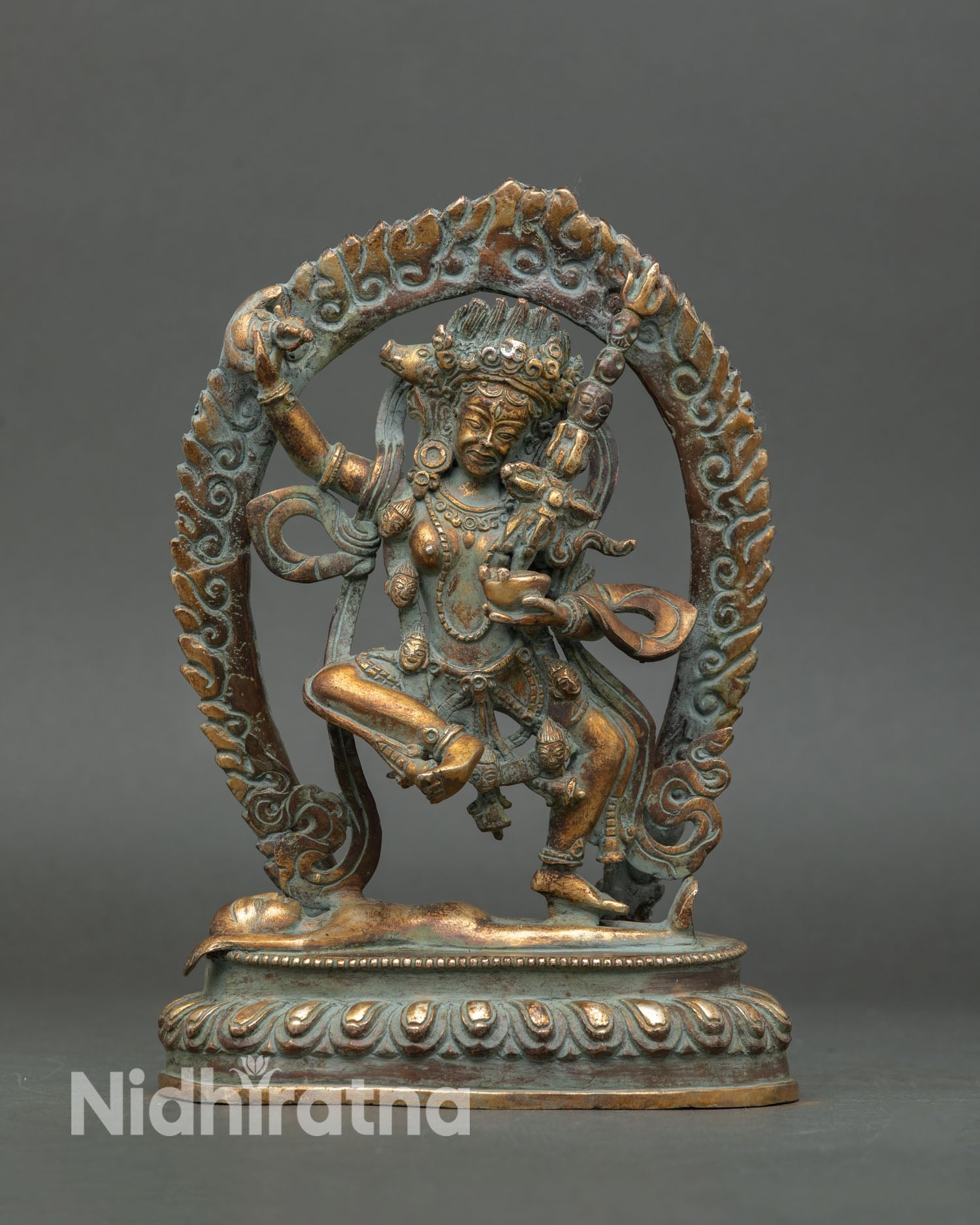 Front view of handmade Dorje Phagmo statue Tibetan dakini sculpture in copper gold gilded antique finish standing on subdued figure
