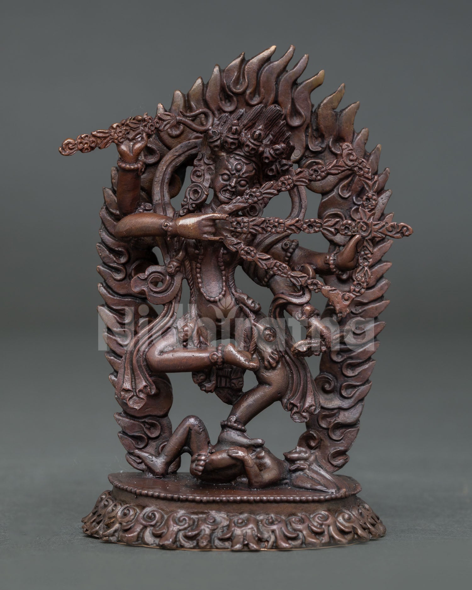 Front view of handmade Kurukulla statue in oxidized copper standing on lotus pedestal with flaming aureole