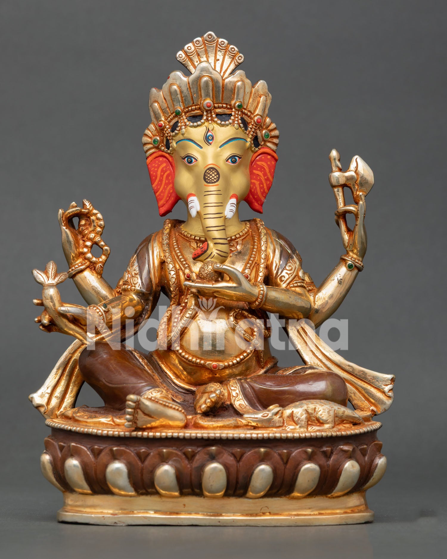 Front view of a handmade Lord Ganesh statue crafted in copper with 24K gold gilding and oxidized finish from Nepal