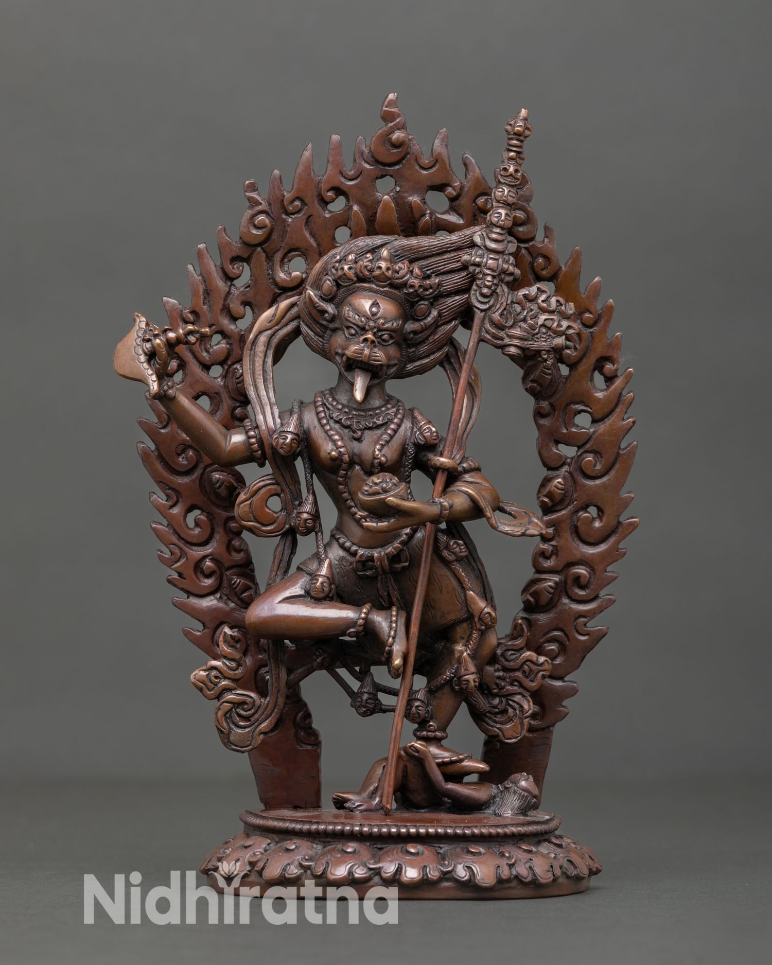 Front view of Lion Faced Dakini statue handcrafted in Nepal with oxidized copper finish showing fierce protector deity on lotus base