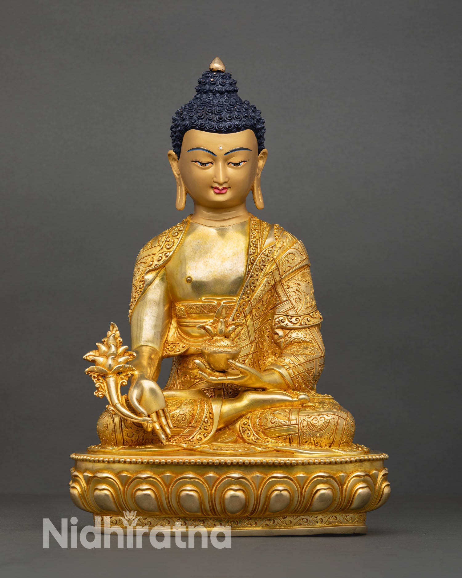 Front view of Medicine Buddha statue handcrafted in Nepal with 24K gold gilding copper body and healing Buddha meditation posture on lotus base